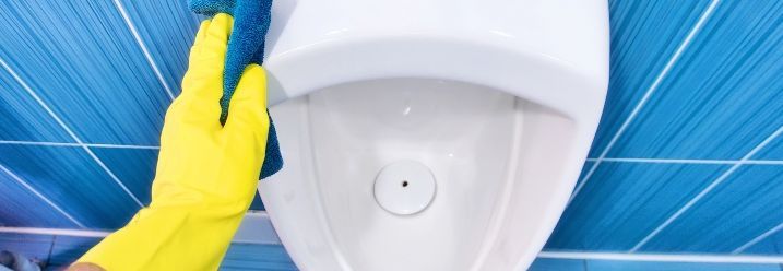 ein urinal säubern mit blauem Hintergrund